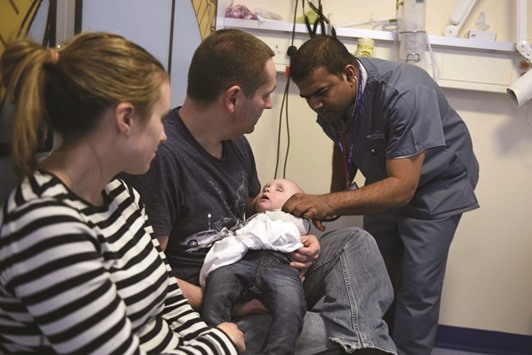 A doctor attends to a young patient in the specialist Childrenu2019s Accident and Emergency department of the u2018Royal Albert Edward Infirmaryu2019 in Wigan, north west England.