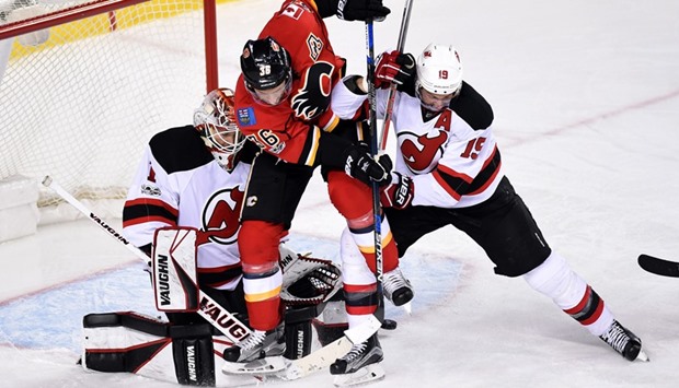 Calgary Flames right wing Troy Brouwer (No 36) and New Jersey Devils center Travis Zajac (No 19) dodge a shot in front of goalie Keith Kinkaid during the third period at Scotiabank Saddledome. Devils won 2-1. PICTURE: USA TODAY Sports