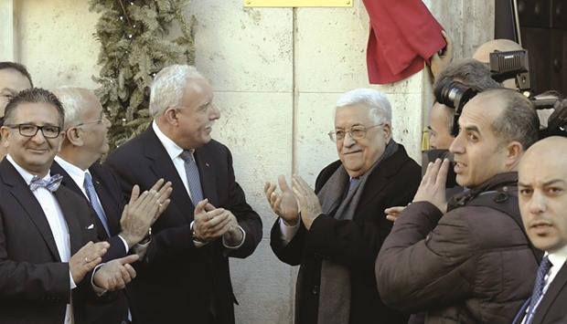 Palestinian President Mahmoud Abbas applauds after he inaugurated the new  Palestinian diplomatic mission to the Holy See with Palestinian ambassador Issa  Kassissieh (left) in Rome yesterday.