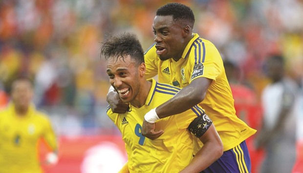 Gabonu2019s Pierre-Emerick Aubameyang (left) celebrates with teammate Malick Evouna after scoring a goal during the 2017 Africa Cup of Nations match against Guinea-Bissau at the Stade de lu2019Amitie Sino-Gabonaise in Libreville yesterday. (Reuters)