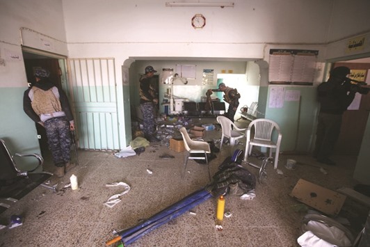 Iraqi Federal Police inspect a hospital used by Islamic State militants during a battle with the militants in the district of Yarimja in southern Mosul yesterday.