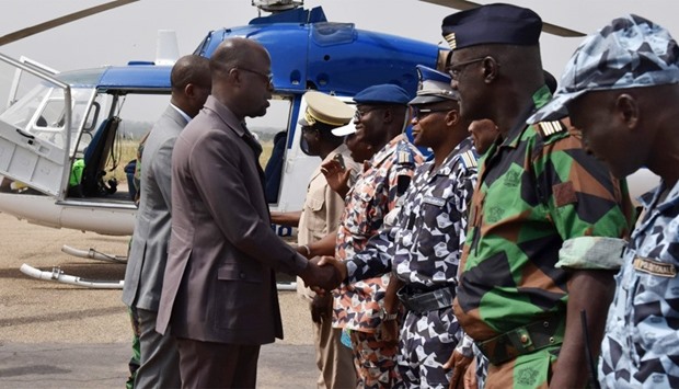 Ivory Coast Defence Minister Alain-Richard Donwahi shakes hands (L) with military commanders