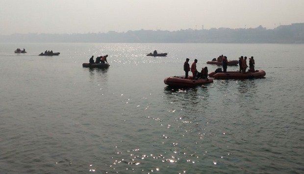 Indian rescue workers search for victims of a boat accident on the river Ganges near Patna