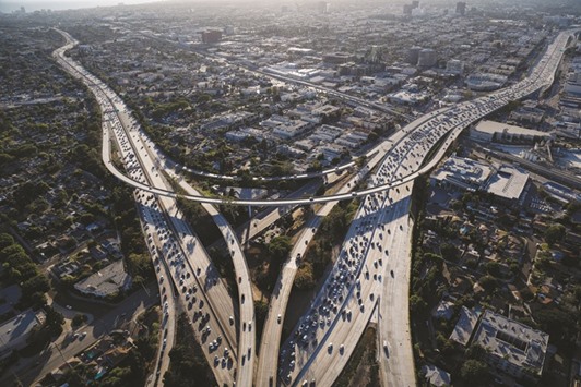 Vehicles move in rush hour traffic between the Interstate 405 and 10 freeways in this aerial photograph taken over Los Angeles, California, US (file). Pressure weighing on the global auto industry for more than a year finally appeared to ease on Wednesday as Volkswagen agreed to $4.3bn in fines for cheating on emissions tests, largely putting the scandal to rest. Less than a day later, the outlook darkened again as Renault and Fiat Chrysler Automobiles were hit with similar allegations of violating clean-air regulations.