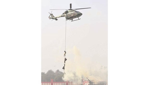 Soldiers abseil from a helicopter during an airshow held as part of Army Day in New Delhi yesterday.
