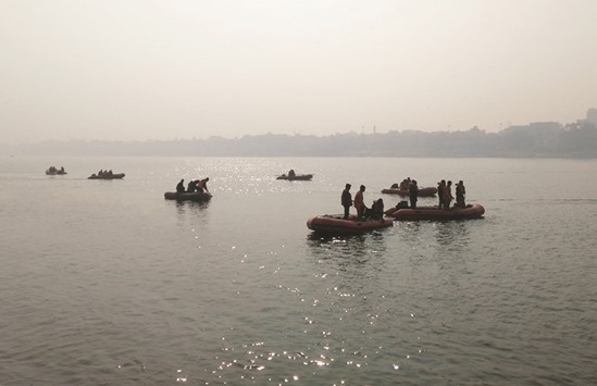 Rescue workers search for victims of a boat accident in Ganges near Patna yesterday.