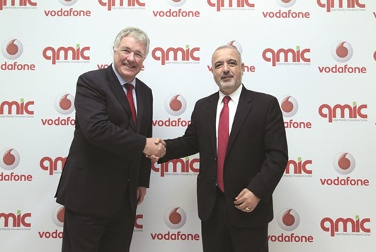 Gray (left) and Abu-Dayya shake hands after concluding the agreement to provide fleet management service.