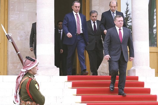 King Abdullah II of Jordan leaves after a meeting at the Jordanian Royal Palace in Amman yesterday.