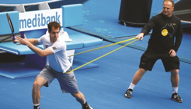 Andy Murray (L) and Novak Djokovic train for the Australian Open in Melbourne yesterday.
