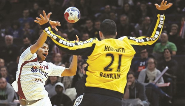 Qataru2019s Ahmad Madadi (left) scores a goal during the 25th IHF Menu2019s World Championship 2017 Group D match against Bahrain at the AccorHotels Arena in Paris yesterday. (AFP)