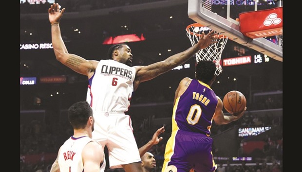 Los Angeles Lakers guard Nick Young (right) shoots against LA Clippers centre DeAndre Jordan (centre) in the first half of their NBA game at the Staples Center in Los Angeles on Saturday. (USA TODAY Sports)