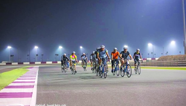 Groups of cyclists enjoying the ride at the Losail International Circuit.
