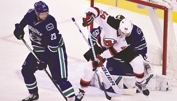Vancouver Canucks goaltender Jacob Markstrom Alexander Edler (R) defend against New Jersey Devils forward Miles Wood during the third period. PICTURE: USA TODAY Sports