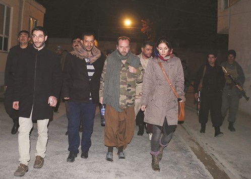 Spanish Red Cross employee Juan Carlos (C) is escorted by Afghan security personnel, following his release after being abducted, in Kunduz on Sunday night.