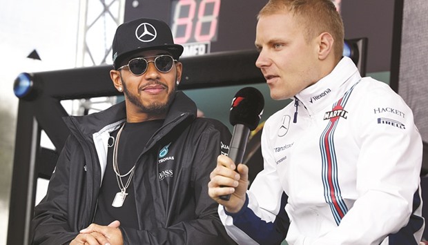 Mercedes new driver Valtteri Bottas promised to push new teammate and triple world champion Lewis Hamilton (left) as hard as possible. (Reuters)