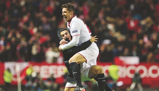 Sevillau2019s Stevan Jovetic (right) celebrates with teammate Wissam Ben Yedder after scoring the winning goal in his side's 2-1 win against Real Madrid on Sunday. (AFP)