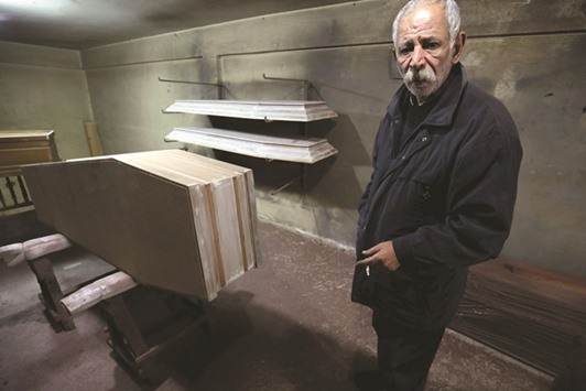 File photo shows Michel Homsi, the last craftsman building handmade coffins in the northern Lebanese city of Tripoli, at his shop.