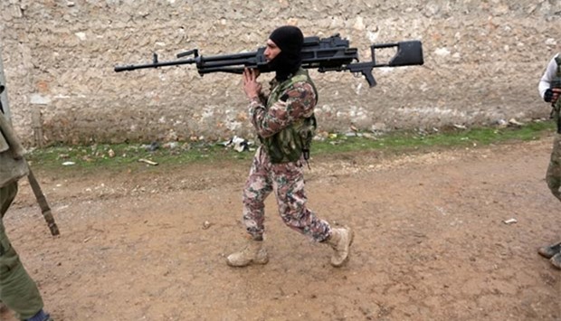 A rebel fighter carries his weapon on the outskirts of the northern Syrian town of al-Bab this week.