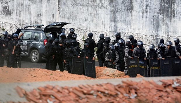 Riot police agents group and stand guard at the Alcacuz Penitentiary Center