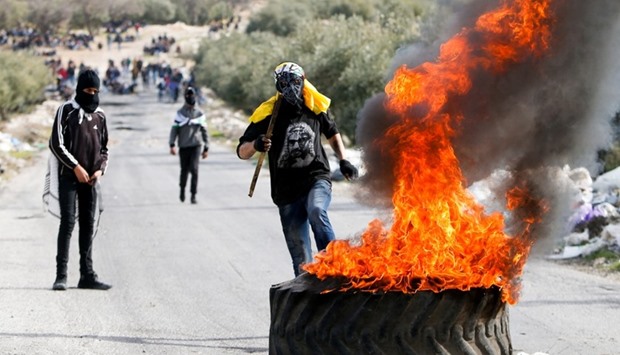 Palestinian protesters take part in a protest following the funeral of Palestinian youth Qusai Al-Amour, who Israeli and Palestinian officials said was shot dead by Israeli border police during a clash with protesters on Monday, in the West Bank village of Tuqu near Bethlehem.