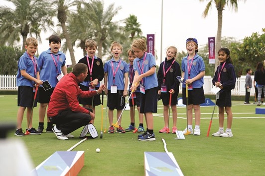 LEARNING CURVE: Chris Nicolls during a teaching session with children at the Doha Golf Club.