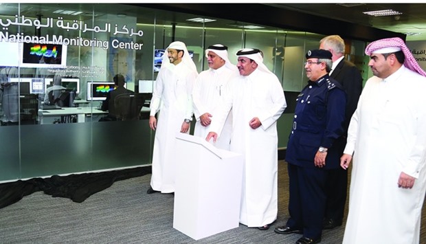 HE Jassim Seif Ahmed al-Sulaiti pressing a button to formally dedicate the upgraded National Monitoring Centre at Al Nasser Tower as others look on: PICTURE: Jayan Orma