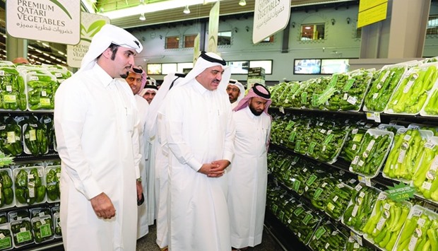 HE the Minister of Municipality and Environment Mohamed bin Abdullah al-Rumaihi inspects Qatari vegetables displayed on a shelf at Al Meera yesterday. PICTURE: Shaji Kayamkulam.