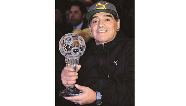 Argentinian football legend Diego Maradona holds a trophy he received during the Italian Hall of Fame 2017 event in Florence, Italy, yesterday.  (Reuters)