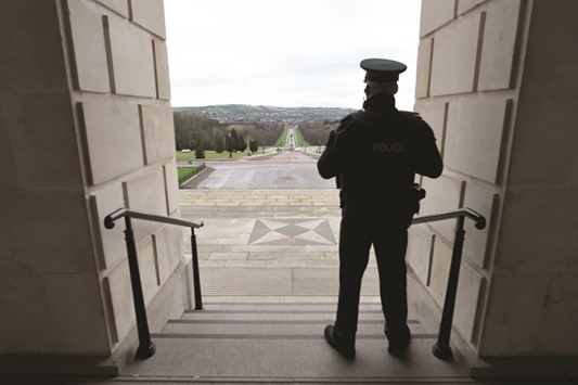 A police officer stands guard on the steps of Stormont Parliament in Belfast, Northern Ireland.