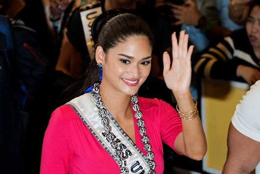 Miss Universe 2016 Pia Wurtzbach waves to the crowd as she arrives for the Miss Universe swimwear fashion show in Cebu City, central Philippines yesterday.
