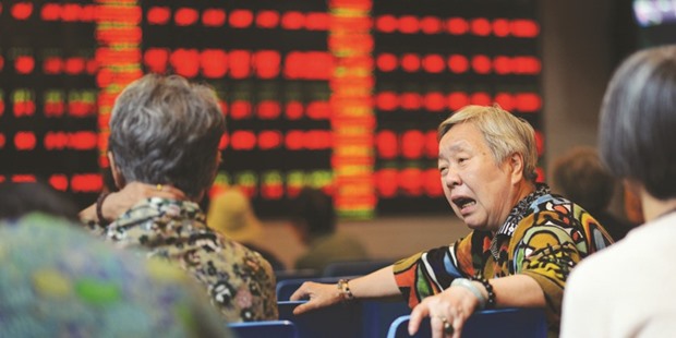 A stock investor reacts in front of a screen showing stock market movements at the Shanghai Stock Exchange. Chinau2019s Cabinet, late Tuesday posted on its website a notice saying it had granted approval in principle for foreign companies to launch IPOs and issue corporate debt and other financing instruments to support the widening of foreign companiesu2019 financing channels.
