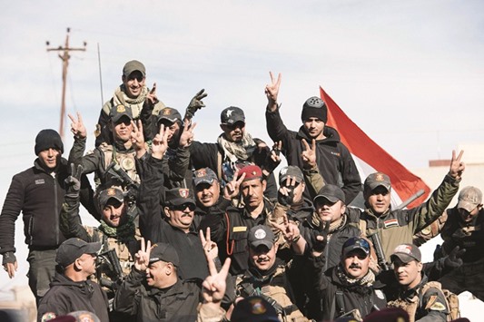 Members of the Iraqi special forces Counter Terrorism Service (CTS) celebrate in their military base in the town of Bartalla yesterday after a top Iraqi commander announced that have they fully retaken east Mosul from the Islamic State (IS) group.