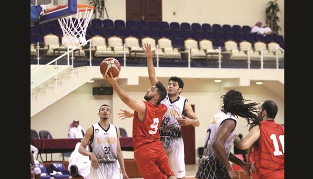 Al Arabiu2019s Omar Mohammed Akhil (second from left) goes for a basket during the Qatar Basketball League match against Al Sadd at Al Gharafa Sports Club yesterday. PICTURE: Othman Iraqi