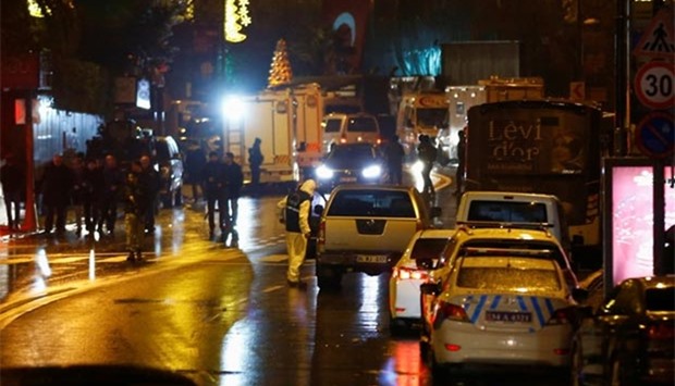 Police forensic experts examine an area near an Istanbul nightclub, following a gun attack in the early hours of Sunday.