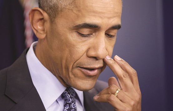US President Barack Obama pauses during his last press conference at the White House in Washington yesterday.