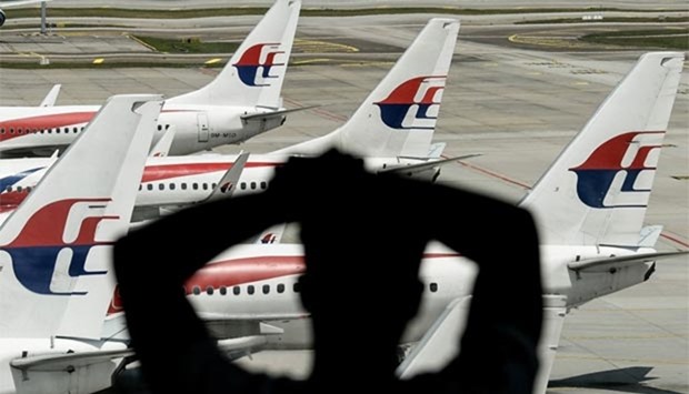 A man looking at Malaysia Airlines' aircraft parked on the tarmac at Kuala Lumpur International Airport in Sepang in this file picture.