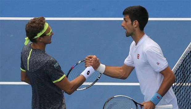 Uzbekistan's Denis Istomin shakes hands after winning his second round match against Serbia's Novak Djokovic in Melbourne on Thursday.