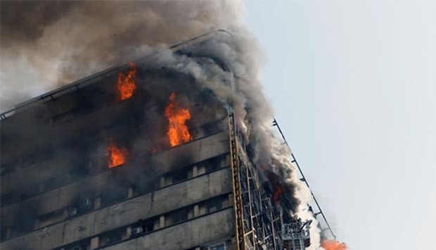 Firefighters battle a blaze that engulfed Iran's oldest high-rise, the 15-storey Plasco building in downtown Tehran on Thursday.