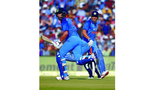 Indiau2019s Mahendra Singh Dhoni (R) and Yuvraj Singh in action during the second ODI against England in Cuttack yesterday. (Reuters)
