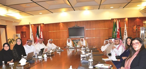 Dr al-Zayani and al-Ageel among others view a presentation at the Goic headquarters in Doha.