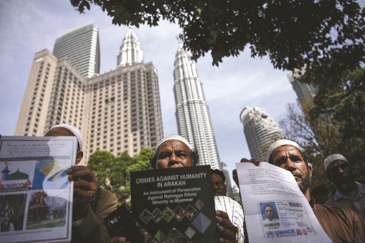 Rohingya refugees living in Malaysia gather outside the venue of the OIC conference on the Rohingya situation in Myanmar, in Kuala Lumpur yesterday.