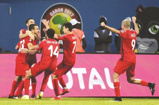 Tunisiau2019s Naim Sliti (left) celebrates with teammates after scoring against Algeria yesterday. (AFP)