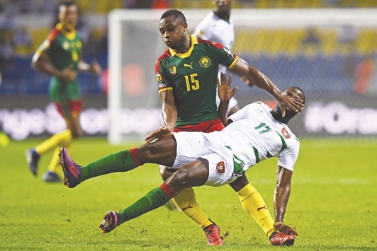 Cameroonu2019s midfielder Sebastien Siani (back) fouls Guinea-Bissauu2019s forward Leocisio Sami during the Africa Cup of Nations Group A match in Libreville on Wednesday. (AFP)