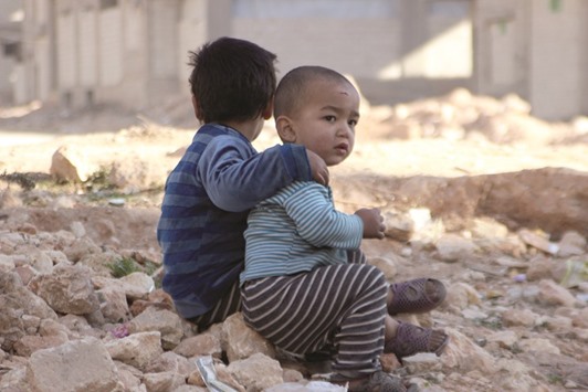 FUTURE IMPERFECT: Children of war in Syriau2019s Aleppo rest on the ruins of the city.