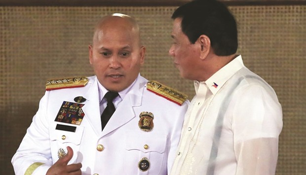 Philippine President Rodrigo Duterte (right) talks to Philippine National Police (PNP) chief Ronald Dela Rosa during the oath-taking of the newly promoted officials of the PNP at the Malacanang presidential palace in metro Manila.