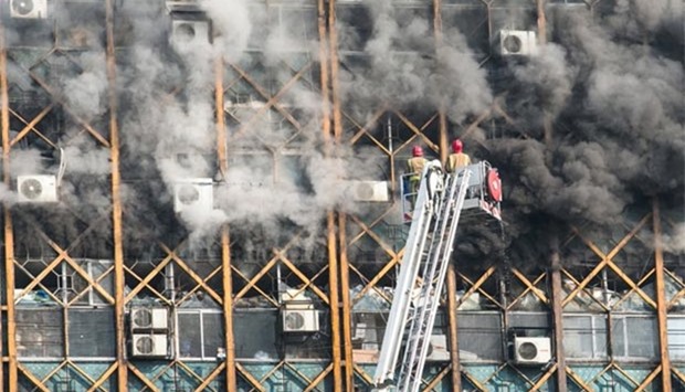 Firefighters try to put out fire in a high-rise building in Tehran on Thursday.