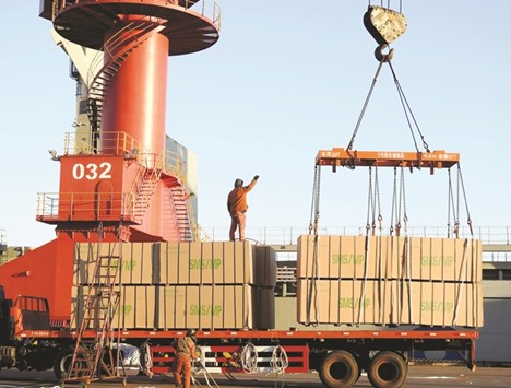 Chinese workers load crates at a port in Lianyungang, Jiangsu province. China recorded its slowest rate of growth in more than a quarter of a century in 2016, data showed yesterday, as the worldu2019s number two economy faces increasing protectionist sentiment.