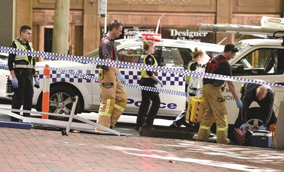 Emergency servicemen and police are seen on Bourke Street after a car ploughed into pedestrians in the centre of Melbourne yesterday.