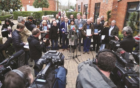 Abuse victims speak to the media holding copies of the Historical Institutional Abuse inquiry report outside the Crowne Plaza hotel in Belfast yesterday.