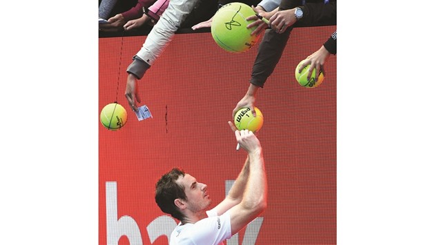 Britainu2019s Andy Murray signs autographs after beating Sam Querrey of the US in their menu2019s singles third round match on day five of the Australian Open yesterday.